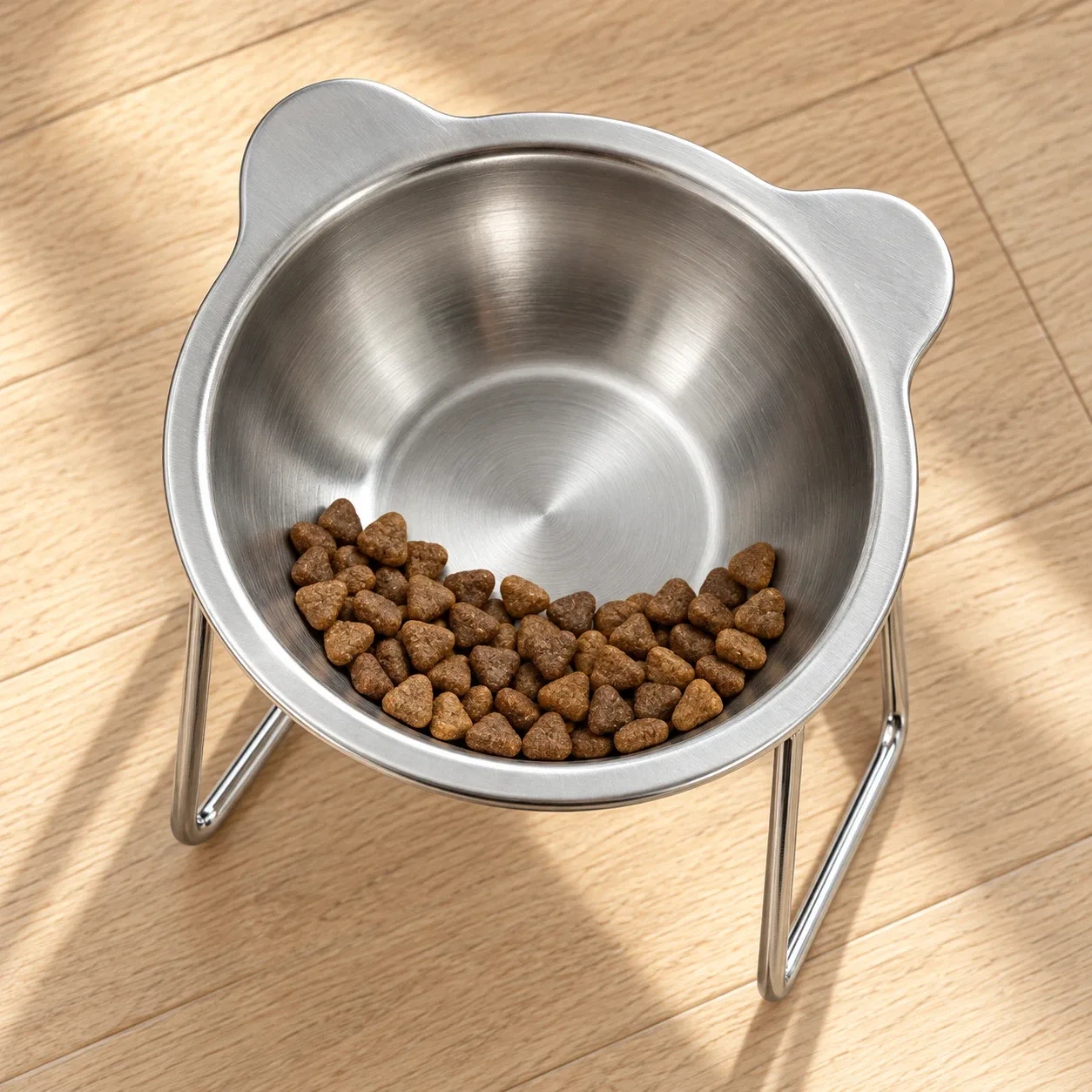 Kibble gathered at the front edge of the tilted bowl